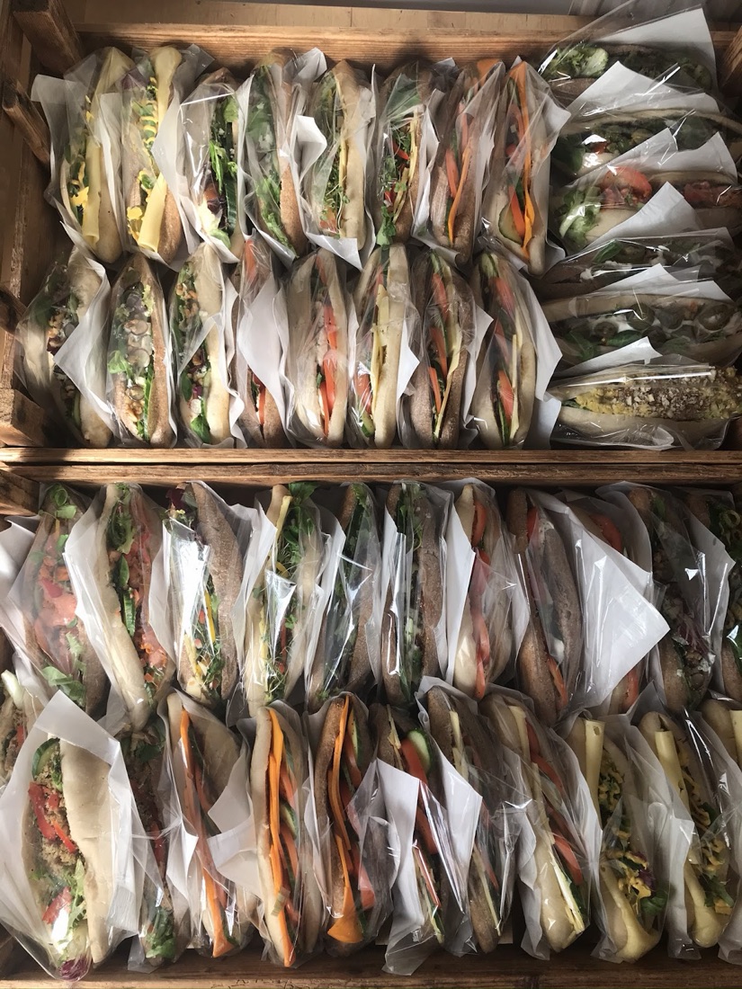 Wooden crates packed with freshly made sourdough sandwiches ready for the lunch run